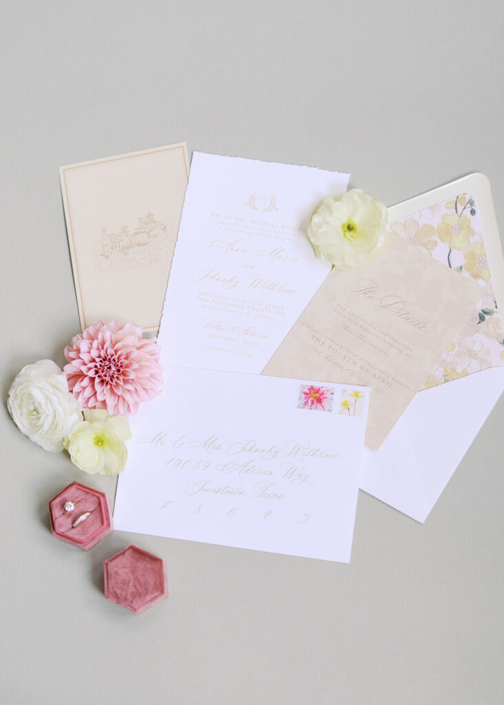 Wedding details flatlay with invitation suite and floral styling at Villa Antonia, photographed by Kelsey Applebaum