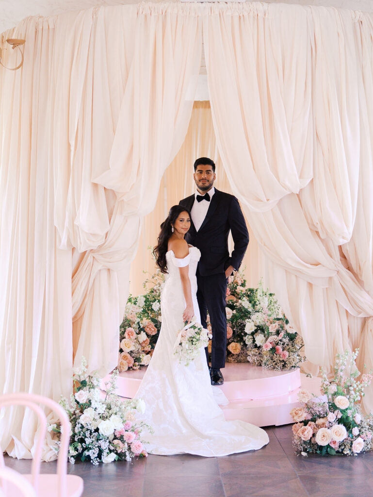 Bride and groom portrait at Villa Antonia with pink florals, captured by Kelsey Applebaum Photography