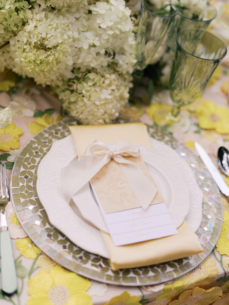 Yellow reception table with garden-inspired florals and romantic details at Villa Antonia, photographed on film by Kelsey Applebaum