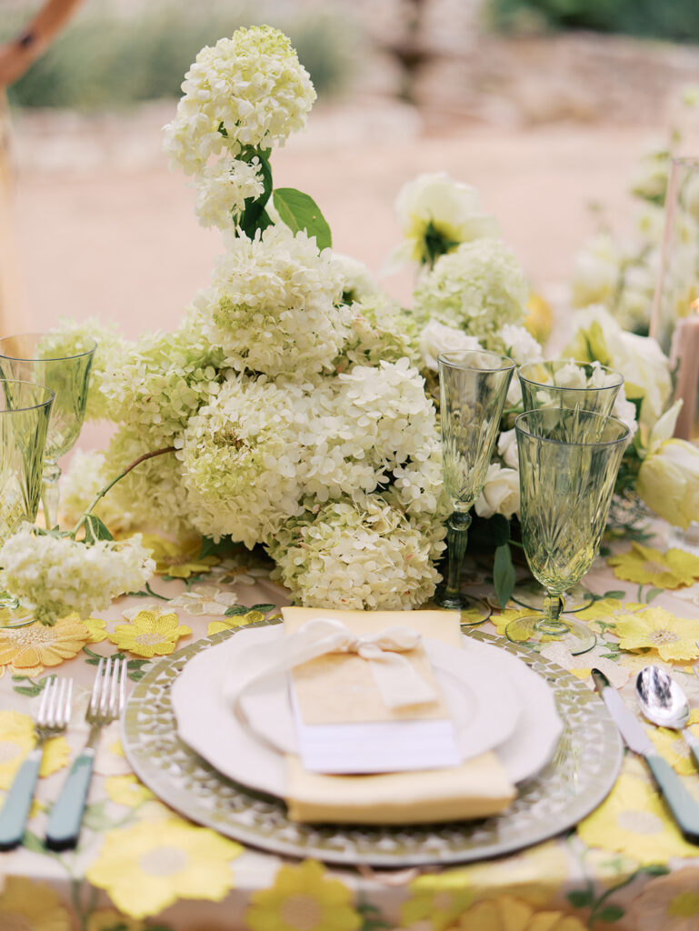 Yellow reception table with garden-inspired florals and romantic details at Villa Antonia, photographed on film by Kelsey Applebaum