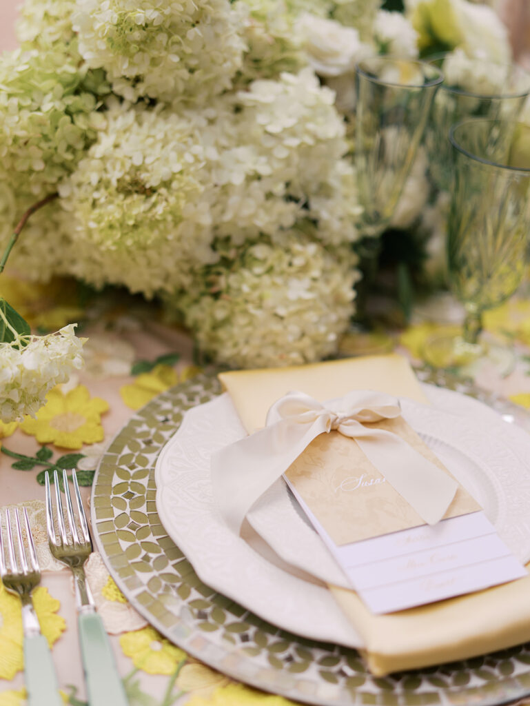 Yellow reception table with garden-inspired florals and romantic details at Villa Antonia, photographed on film by Kelsey Applebaum