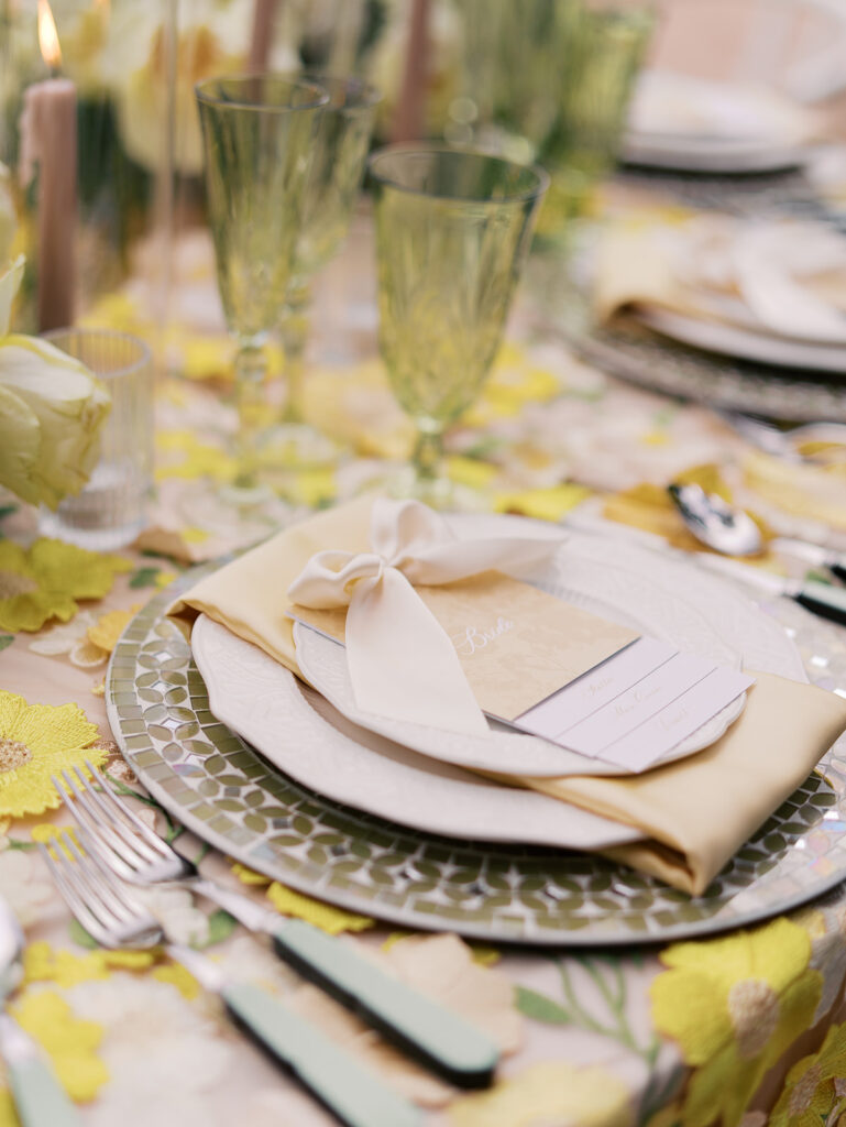 Yellow reception table with garden-inspired florals and romantic details at Villa Antonia, photographed on film by Kelsey Applebaum