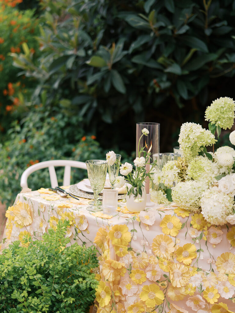 Yellow reception table with garden-inspired florals and romantic details at Villa Antonia, photographed on film by Kelsey Applebaum