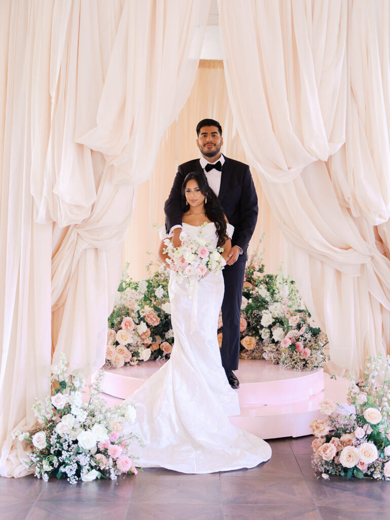 Bride and groom portrait at Villa Antonia with pink florals, captured by Kelsey Applebaum Photography