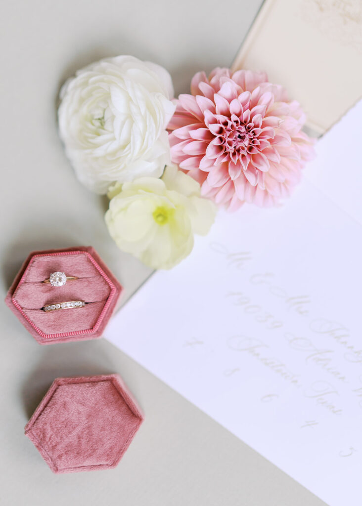 Wedding details flatlay with invitation suite and floral styling at Villa Antonia, photographed by Kelsey Applebaum