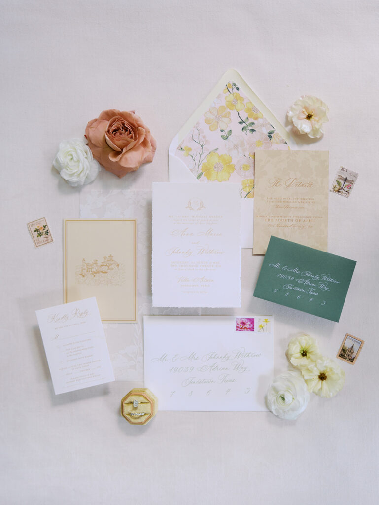 Wedding details flatlay with invitation suite and floral styling at Villa Antonia, photographed by Kelsey Applebaum