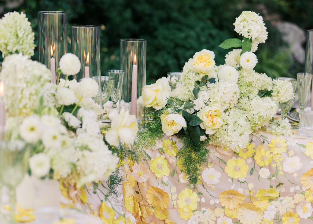 Wedding tablescape with pastel yellow linens and roses at Villa Antonia, photographed by Kelsey Applebaum
