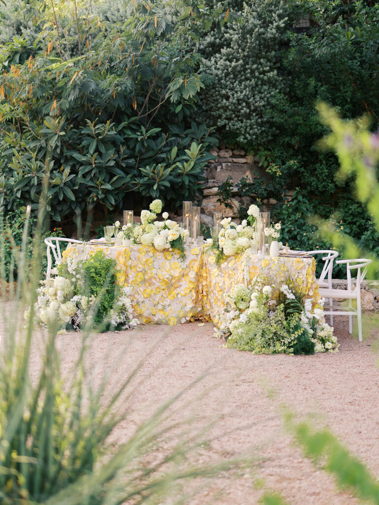 Wedding tablescape with pastel yellow linens and florals by Truth & Blooms at Villa Antonia, photographed by Kelsey Applebaum