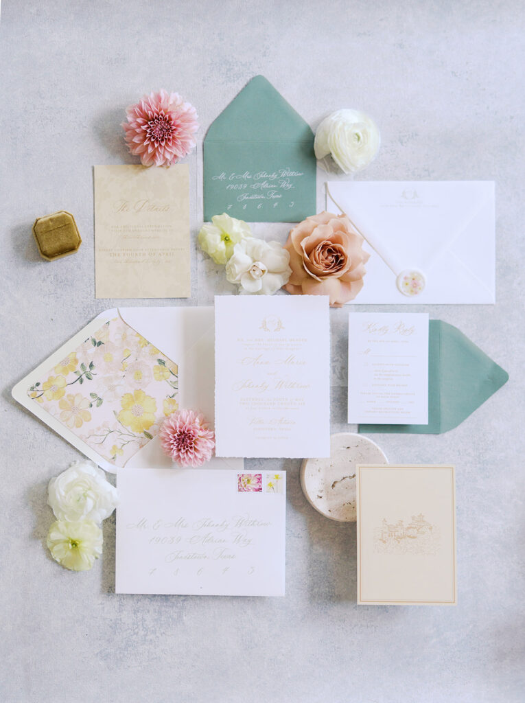 Wedding details flatlay with invitation suite and floral styling at Villa Antonia, photographed by Kelsey Applebaum