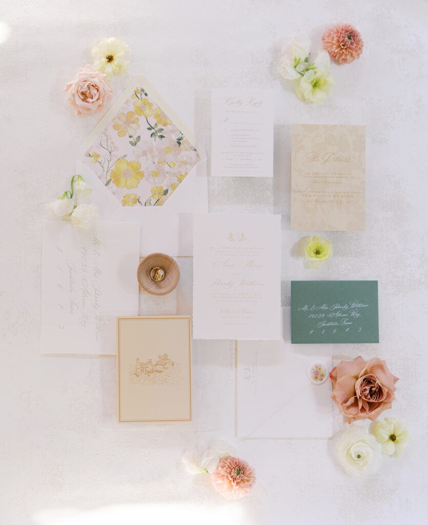 Wedding details flatlay with invitation suite and floral styling at Villa Antonia, photographed by Kelsey Applebaum