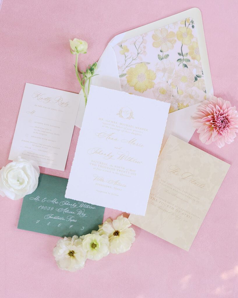 Wedding details flatlay with invitation suite and floral styling at Villa Antonia, photographed by Kelsey Applebaum