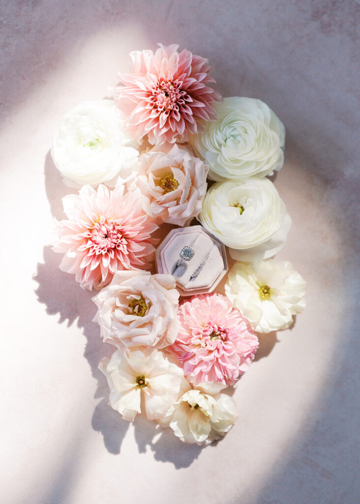 Wedding details flatlay with invitation suite and floral styling at Villa Antonia, photographed by Kelsey Applebaum