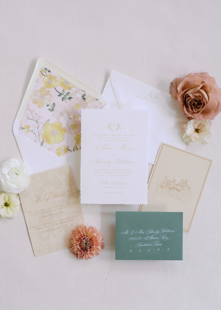 Wedding details flatlay with invitation suite and floral styling at Villa Antonia, photographed by Kelsey Applebaum