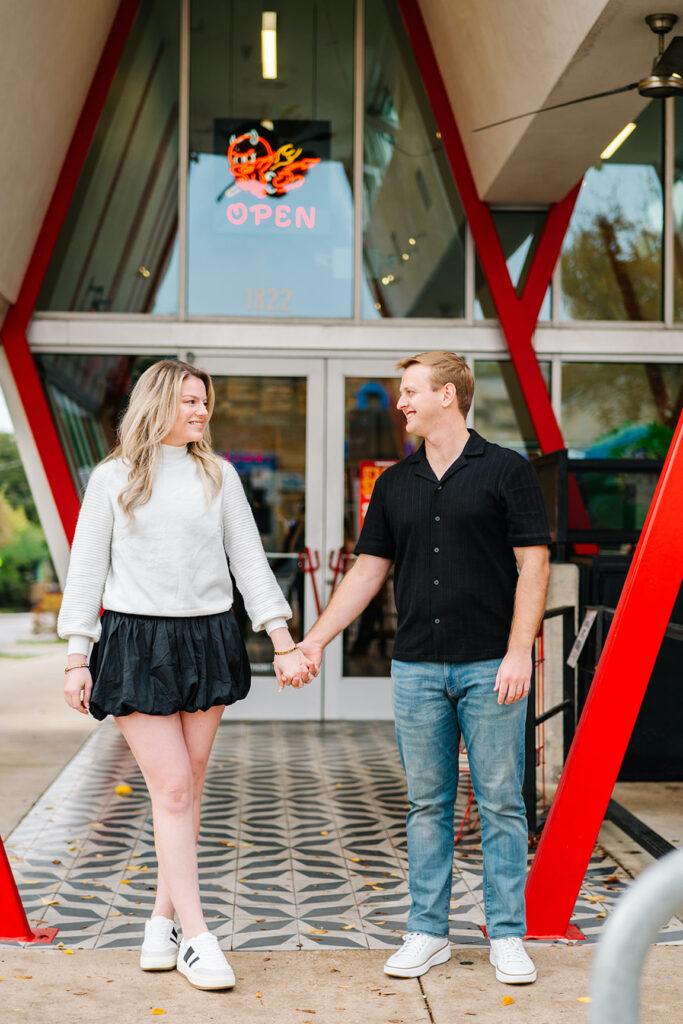 engagement session on the iconic south congress on film bride and groom walking