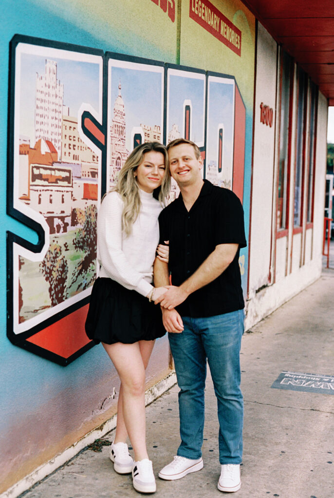 engagement session on the iconic south congress on film bride and groom walking