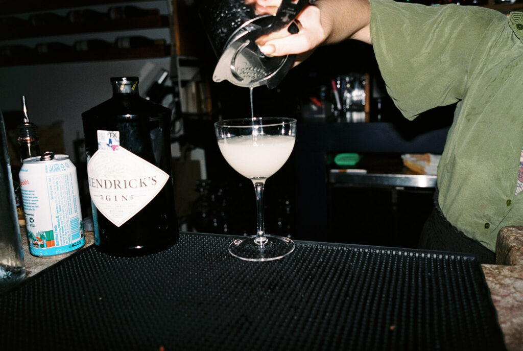 Film photograph of rehearsal dinner guests enjoying an intimate evening at Intero Restaurant.