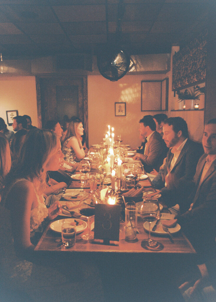 Film photograph of rehearsal dinner guests enjoying an intimate evening at Intero Restaurant.