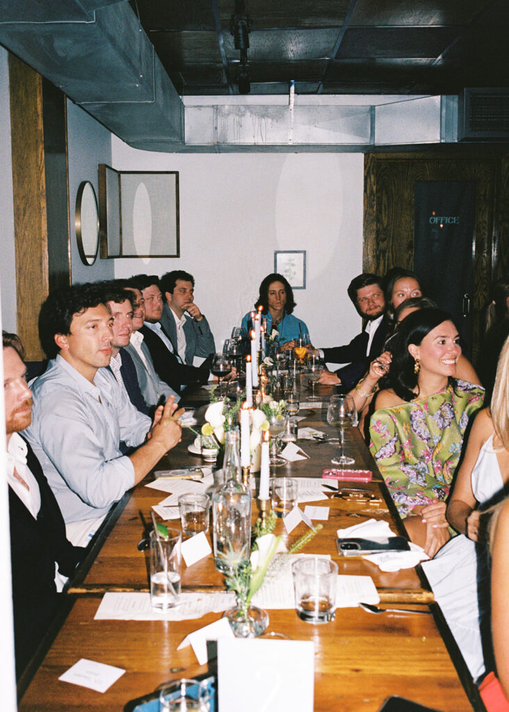 The couple surrounded by family and friends at their intimate rehearsal dinner at Intero Restaurant in Austin, TX, glowing on film