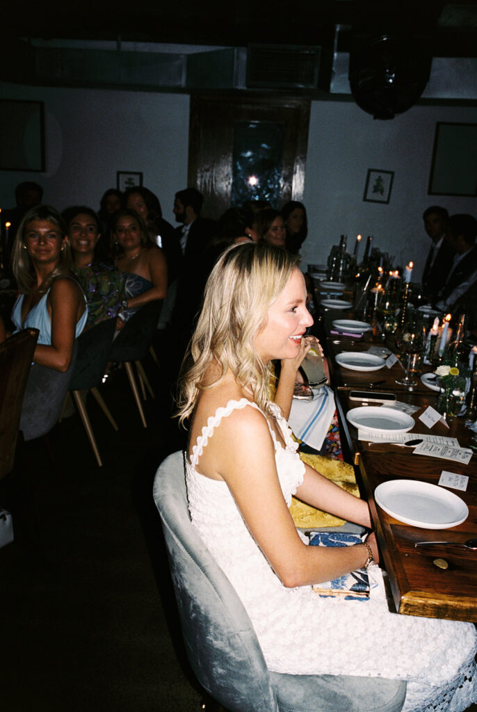 The couple surrounded by family and friends at their intimate rehearsal dinner at Intero Restaurant in Austin, TX, glowing on film