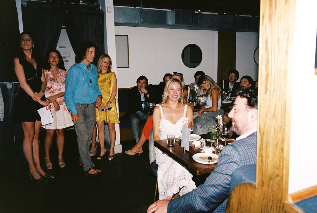 The couple surrounded by family and friends at their intimate rehearsal dinner at Intero Restaurant in Austin, TX, glowing on film