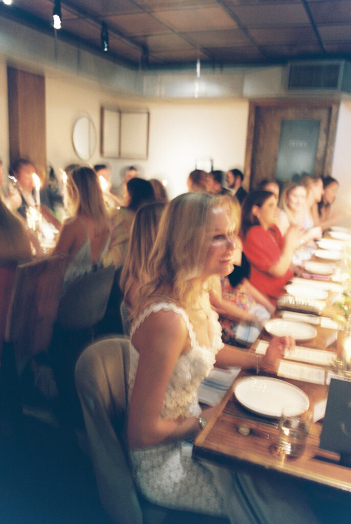 The couple surrounded by family and friends at their intimate rehearsal dinner at Intero Restaurant in Austin, TX, glowing on film