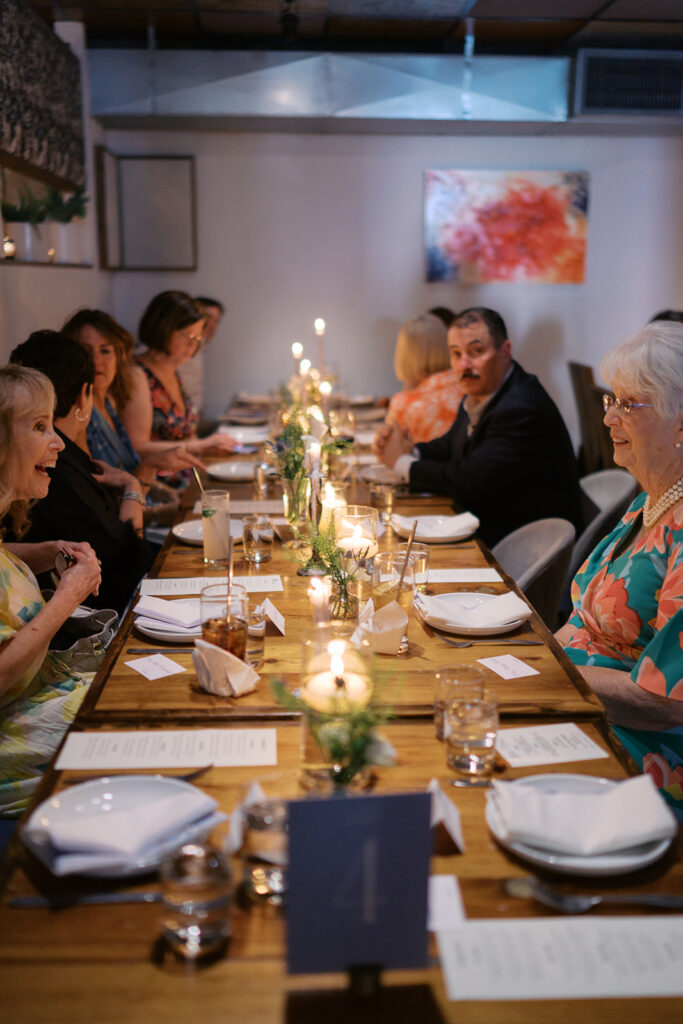 The couple surrounded by family and friends at their intimate rehearsal dinner at Intero Restaurant in Austin, TX, glowing on film