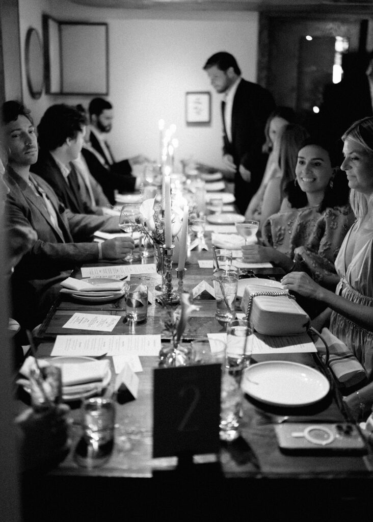 Film photograph of rehearsal dinner guests enjoying an intimate evening at Intero Restaurant.