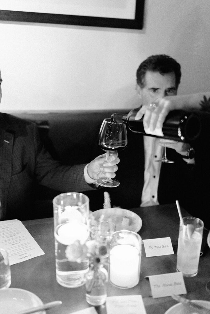Film photograph of rehearsal dinner guests enjoying an intimate evening at Intero Restaurant.