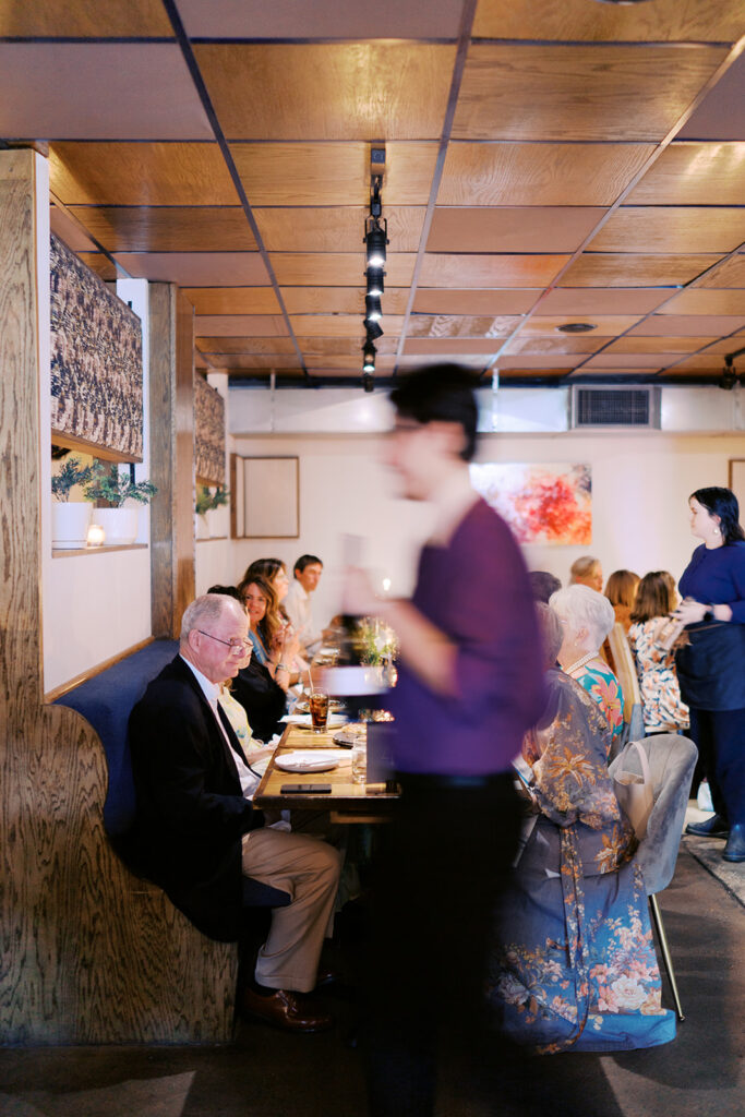 The couple surrounded by family and friends at their intimate rehearsal dinner at Intero Restaurant in Austin, TX, glowing on film