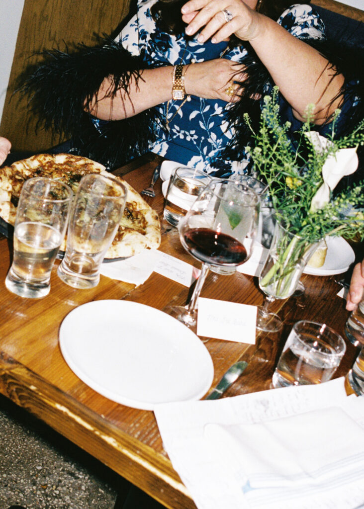 Film photograph of rehearsal dinner guests enjoying an intimate evening at Intero Restaurant.
