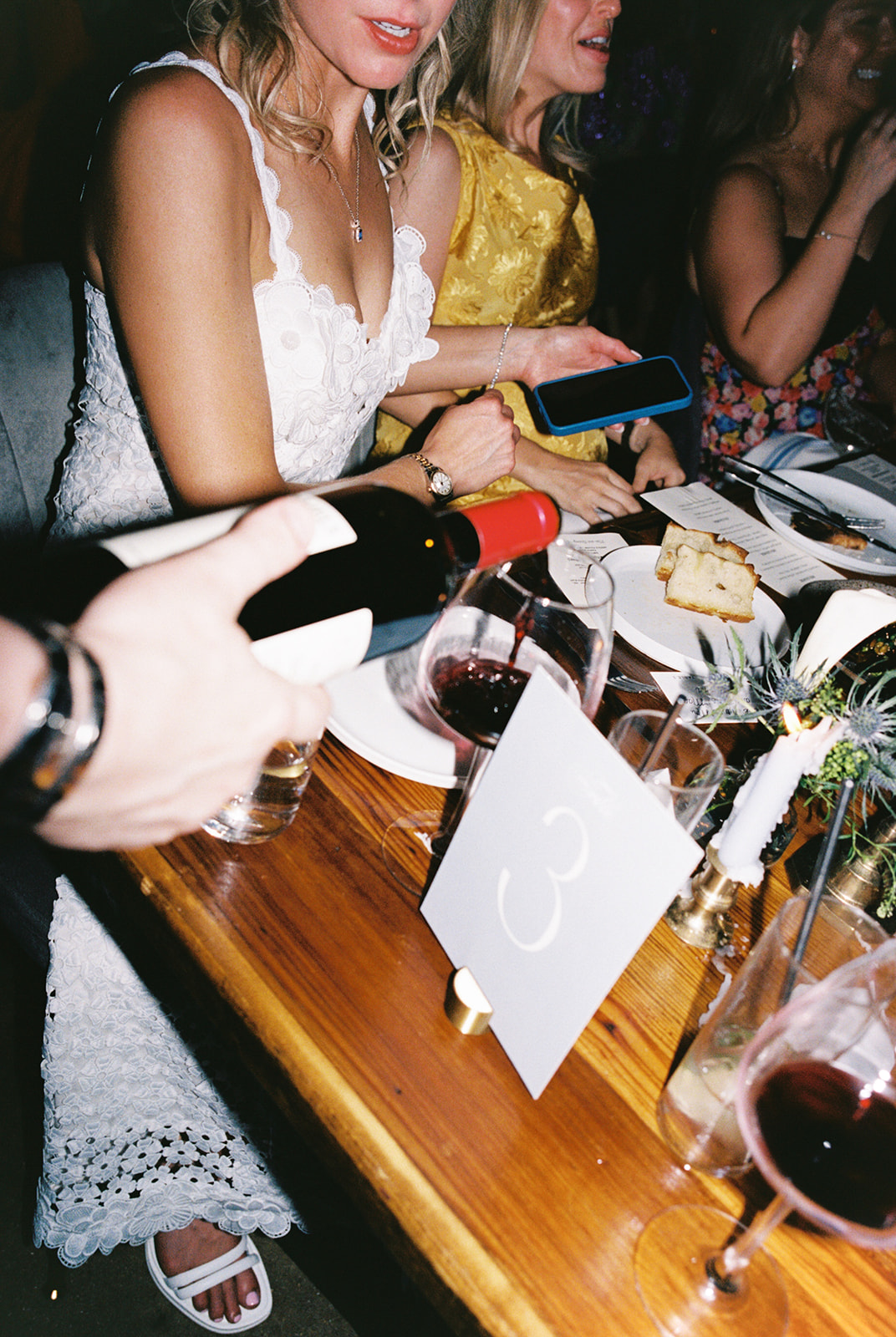 Film photograph of rehearsal dinner guests enjoying an intimate evening at Intero Restaurant.