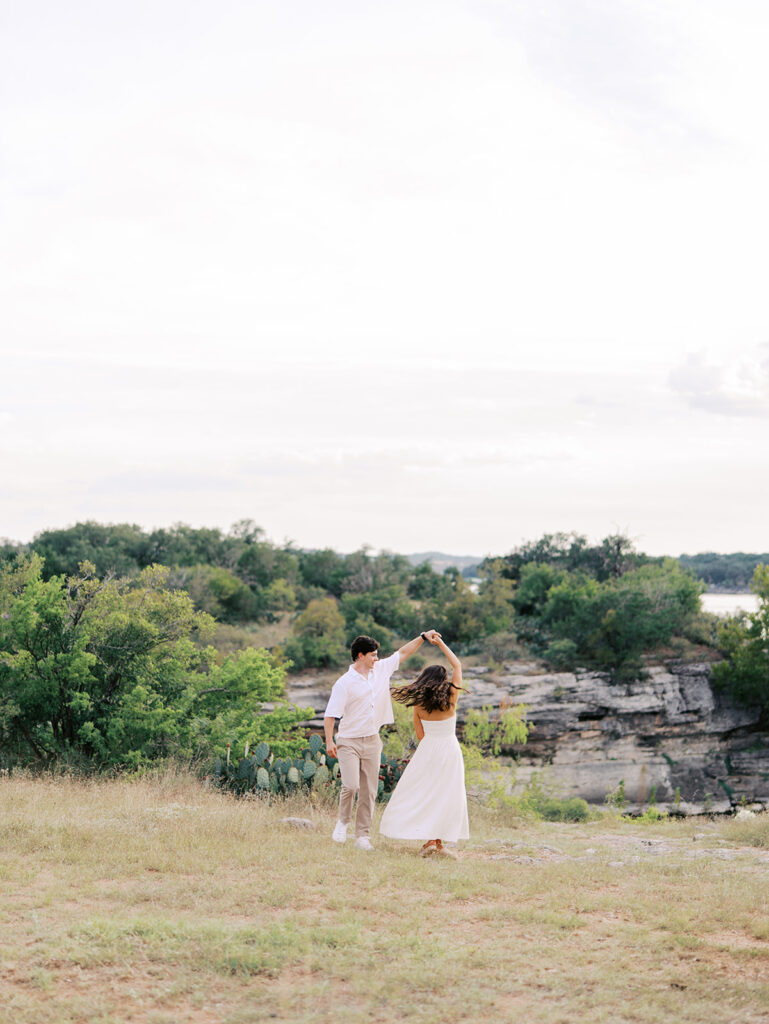 Playful and candid Lake Travis proposal photography of newly engaged couple enjoying the moment together.