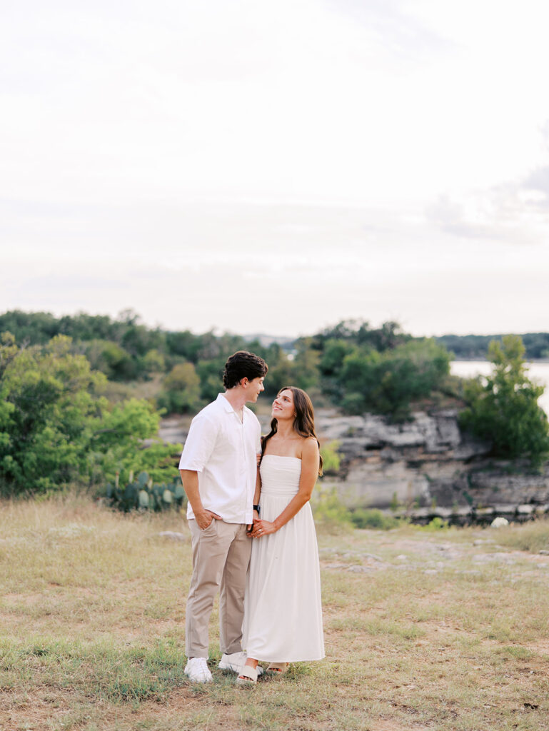 Playful and candid Lake Travis proposal photography of newly engaged couple enjoying the moment together.