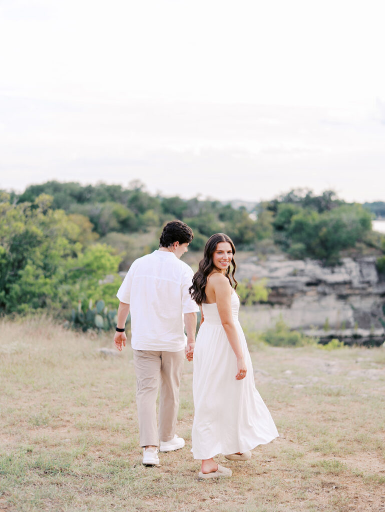 Playful and candid Lake Travis proposal photography of newly engaged couple enjoying the moment together.