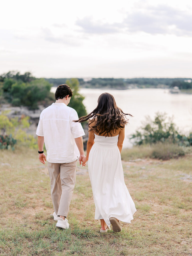 Playful and candid Lake Travis proposal photography of newly engaged couple enjoying the moment together.