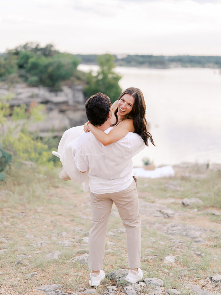 Playful and candid Lake Travis proposal photography of newly engaged couple enjoying the moment together.