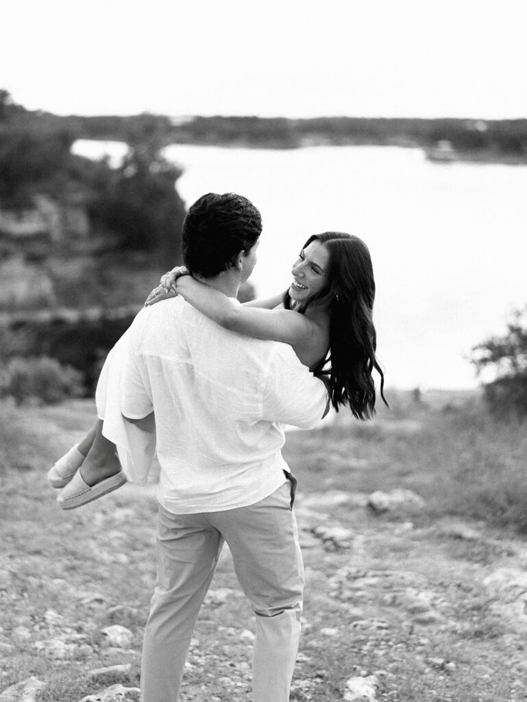 Playful and candid Lake Travis proposal photography of newly engaged couple enjoying the moment together.