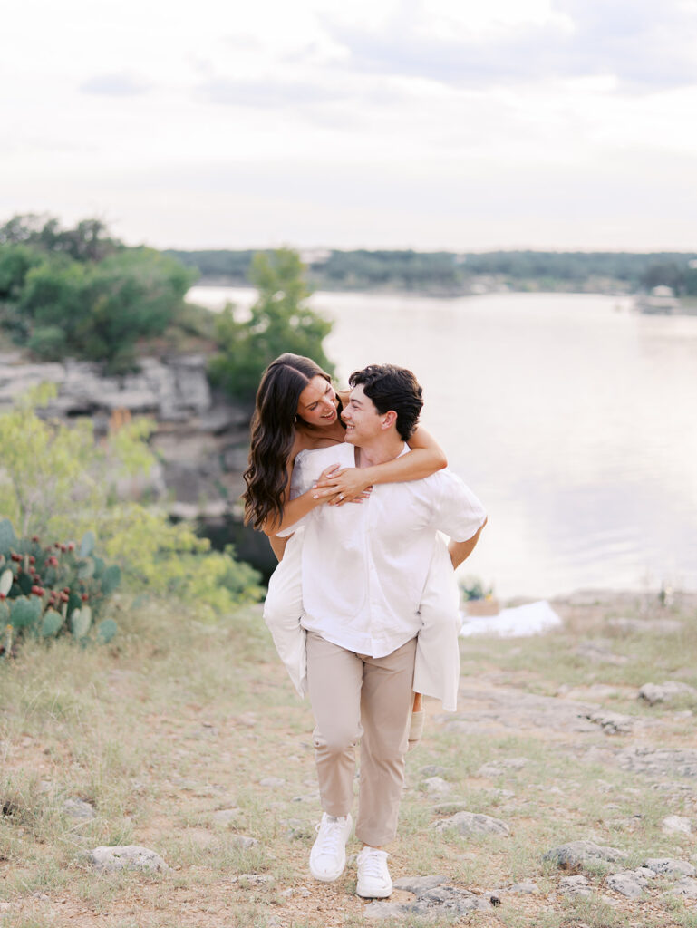 Playful and candid Lake Travis proposal photography of newly engaged couple enjoying the moment together.