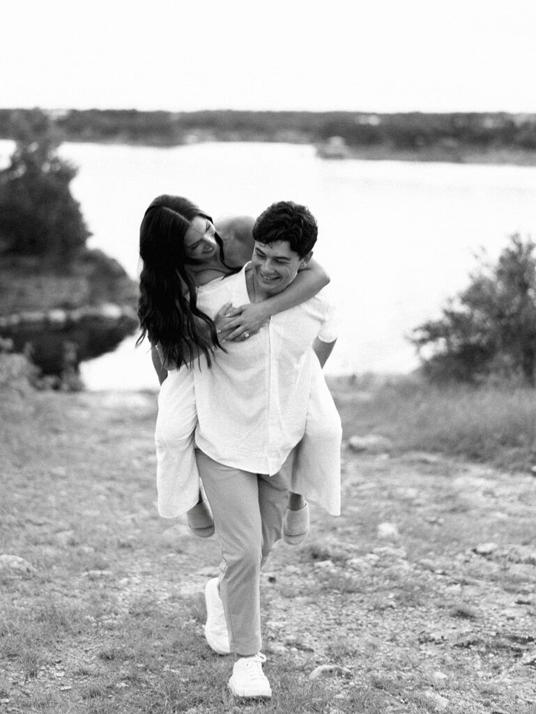 Playful and candid Lake Travis proposal photography of newly engaged couple enjoying the moment together.