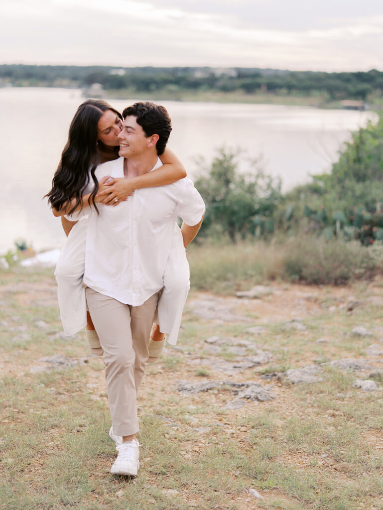 Playful and candid Lake Travis proposal photography of newly engaged couple enjoying the moment together.