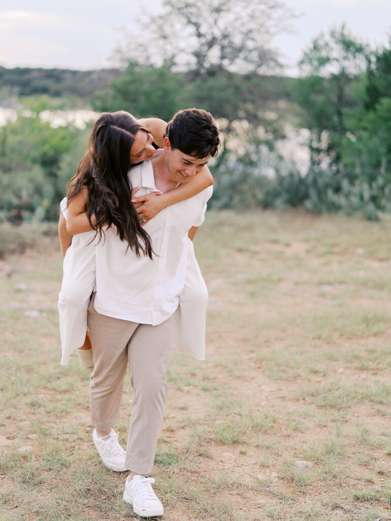 Playful and candid Lake Travis proposal photography of newly engaged couple enjoying the moment together.