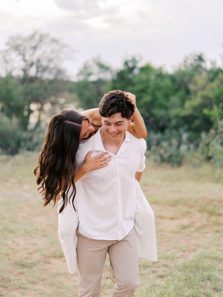 Playful and candid Lake Travis proposal photography of newly engaged couple enjoying the moment together.