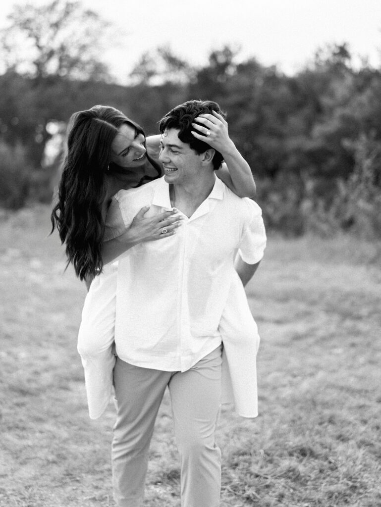 Playful and candid Lake Travis proposal photography of newly engaged couple enjoying the moment together.