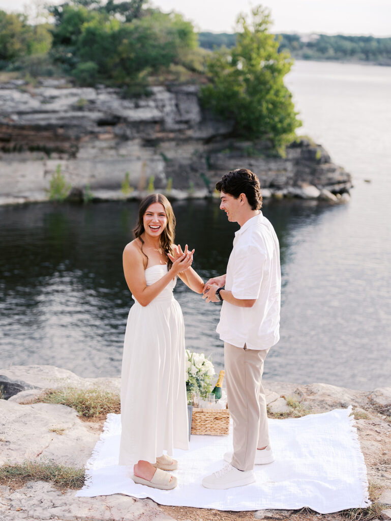 Surprise proposal on Lake Travis as he kneels with a ring, captured in dreamy, romantic photography.