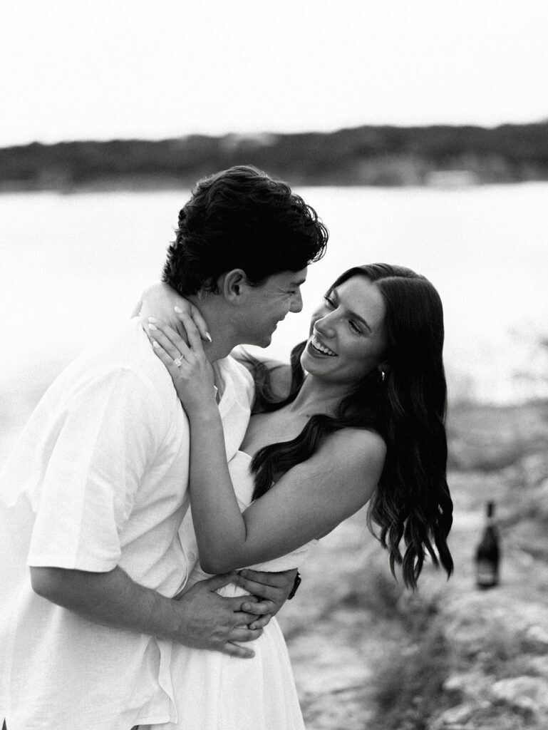 Playful and candid Lake Travis proposal photography of newly engaged couple enjoying the moment together.