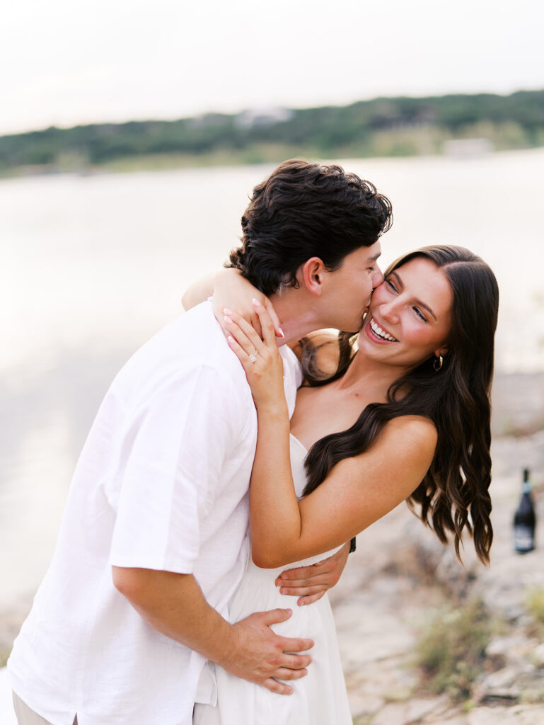 Playful and candid Lake Travis proposal photography of newly engaged couple enjoying the moment together.