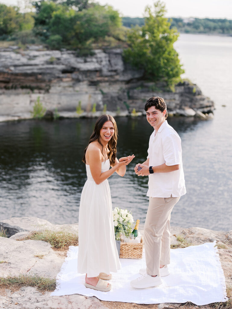 Surprise proposal on Lake Travis as he kneels with a ring, captured in dreamy, romantic photography.