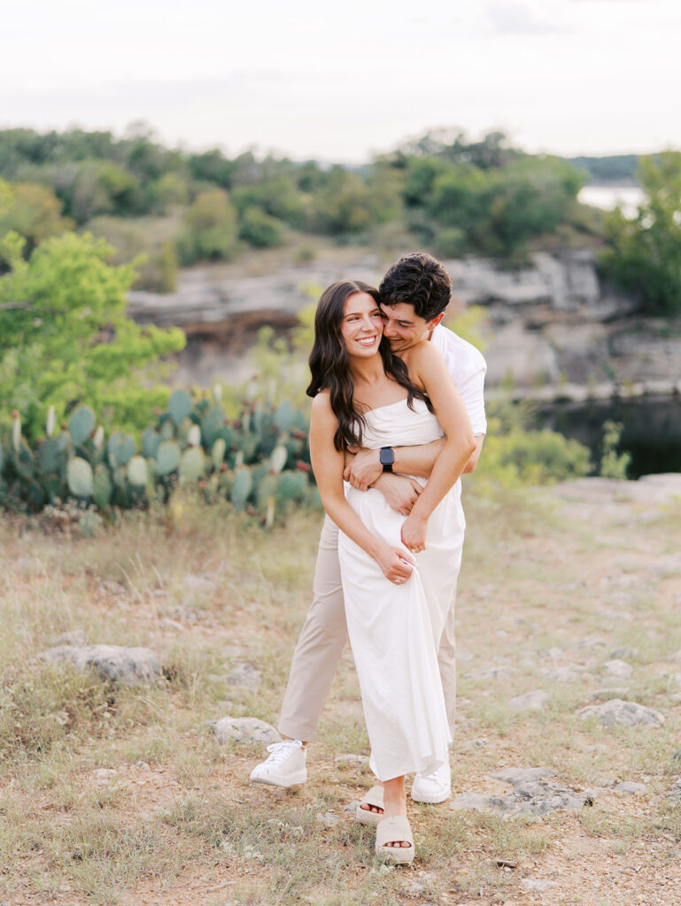 Playful and candid Lake Travis proposal photography of newly engaged couple enjoying the moment together.