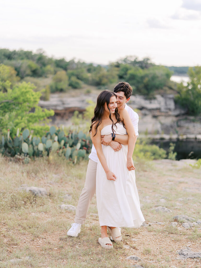 Playful and candid Lake Travis proposal photography of newly engaged couple enjoying the moment together.