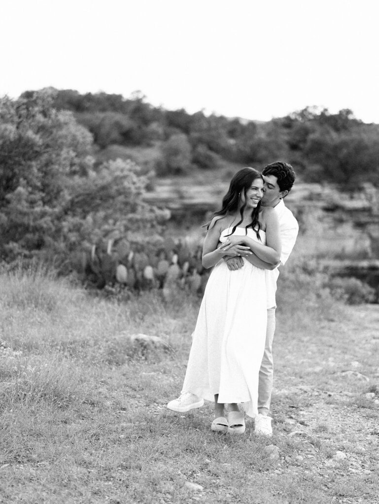 Playful and candid Lake Travis proposal photography of newly engaged couple enjoying the moment together.